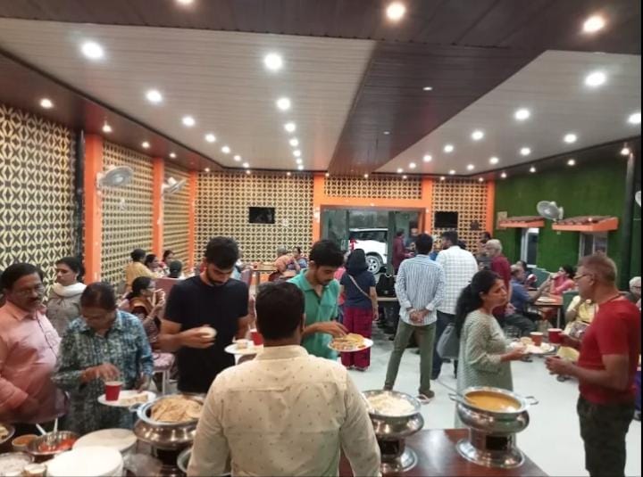 Guests serving themselves at a busy party function